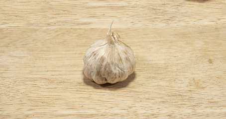 sliced garlic, garlic clove, garlic bulb in wicker basket place on chopping block on vintage wooden background