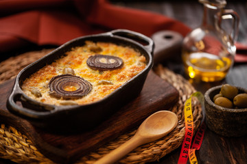 Cod with Cream - dish baked in the oven that consists of layers of cod (dry and salted cod), onion and olives.