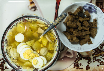 The sour soup made of rye flour with eggs on dish