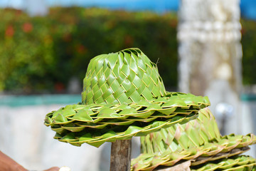 Several straw hats in a heap, on the stick