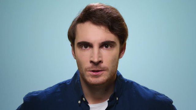 Angry man looking at camera. Male model with aggressive face expression