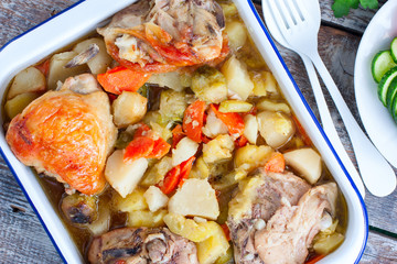 Baked chicken thighs with brussels sprouts, potatoes, carrots, onions, selective focus