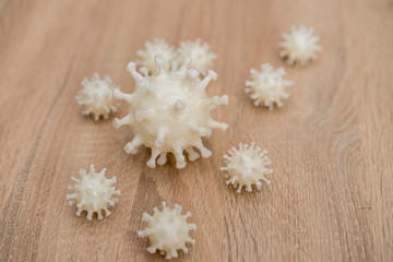 covid19, 3d printed representation of the virus on a wooden surface. home security and protection against viruses