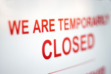 Sign in a shop window: We are temporarily closed. Covid-19 isolation and closed shops.