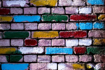 Wall with colored bricks. Old wall with painted bricks. Textured colorful background