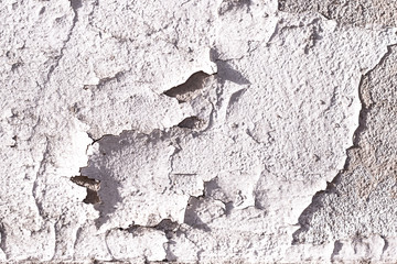 Old wall fragment. Old wall part with damaged plaster and paint.