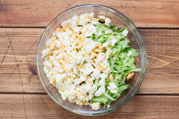 Step by step cooking of summer cold soup with beets and kefir, step 4 - adding chopped boiled eggs, top view, top view, selective focus