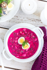 Traditional cold summer beetroot soup with vegetables, top view, selective focus