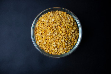 Bowl of Toor Dal/Yellow Dal, isolated, yop view, black background, close up.