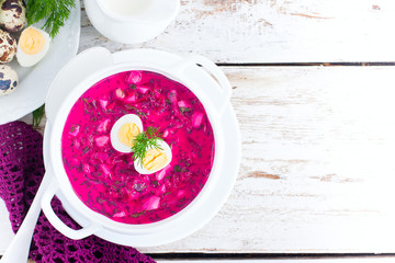 Traditional cold summer beetroot soup with vegetables, top view, selective focus, copy space