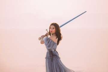 Art Portrait young beautiful brave warrior woman princess. Medieval queen holds steel silver magic...