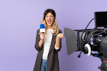 Fototapeta premium Reporter teenager girl holding a microphone and reporting news isolated on purple background frustrated by a bad situation