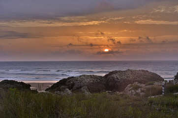 beautiful orange sunset over the sea and rocks