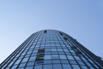 Fototapeta na wymiar Huge glass business building on blue sky background