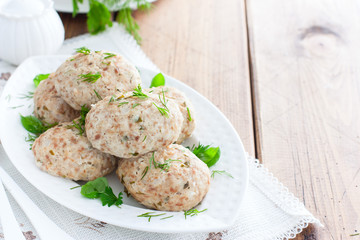 Dietary turkey cutlets on a white dish, horizontal, copy space