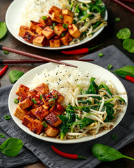 Fried Asian tofu in sweet chilli glaze served with rice, steamed spinach and beansprouts. Vegetable healthy food