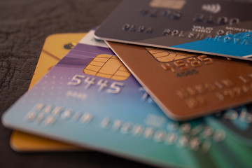 Macro shot of colorful credit cards on brown leather background