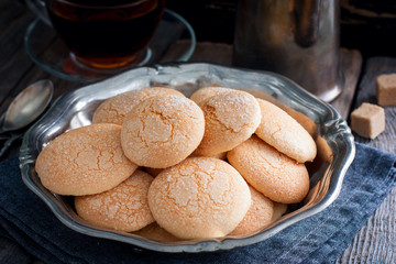 Homemade sugar cookies with craquelure crust in a metal vase, selective focus