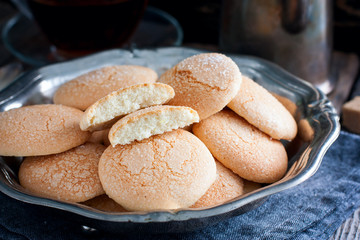 Homemade sugar cookies with craquelure crust in a metal vase, selective focus
