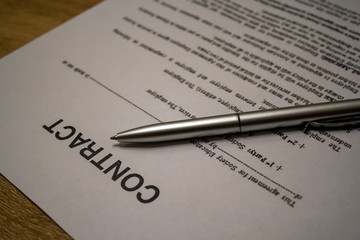 Macro shot of contract and pen on table