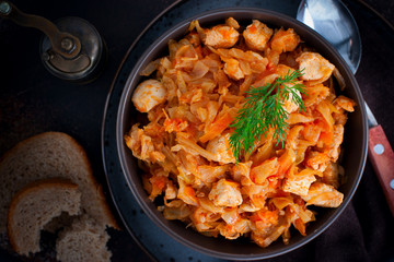 Braised cabbage with chicken breast fillet, top view, selective focus