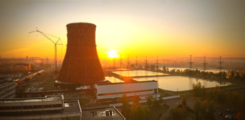 sunrise over a power plant. Cooling tower on the background of sunrise