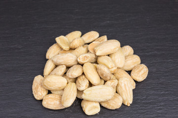 heap of salted roasted almonds for a healthy snack