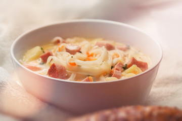 diet vermicelli soup in a plate on a table with a spoon 