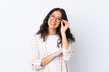 Mixed race woman over isolated white background with glasses and happy