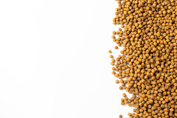 Above or Top view of animal food. Brown Dried dog food on white background. Grain pet food banner background with copy space for text design.