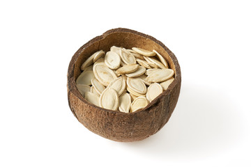 Pumpkin grains in small bowls with coconut on a white background - obrazy, fototapety, plakaty