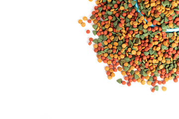 Above or Top view. Colourful Dried dog food in blue bowl on white background. Grain pet food banner background with copy space for text design.