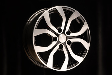 Obraz premium New car alloy wheel, close-up on a black background