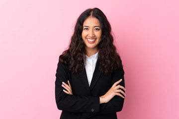 Mixed race business woman over isolated pink background laughing © luismolinero
