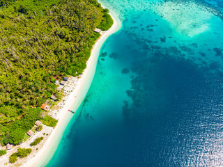 Aerial view tropical paradise pristine beach rainforest blue lagoon bay coral reef caribbean sea turquoise water at Banyak Islands Indonesia Sumatra remote travel adventure away from it all