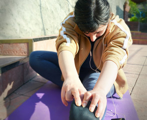 Naklejka na ściany i meble Woman practicing yoga pose indoors. Young woman meditates while practicing yoga. Calmness and relax, woman happiness.