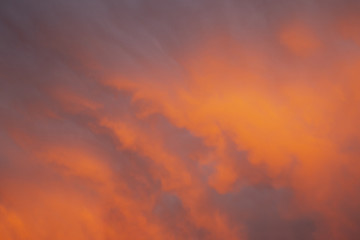 Soft and Vibrant bright orange purple and blue sky full of clouds at sunset to be used as a background with copy space