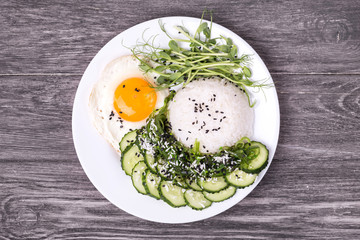 Rice with cucumber, scrambled eggs, microgreen and Japanese wakame seaweed salad.