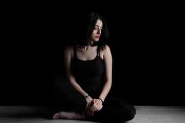 Fototapeta na wymiar Portrait of young woman sitting on a floor.