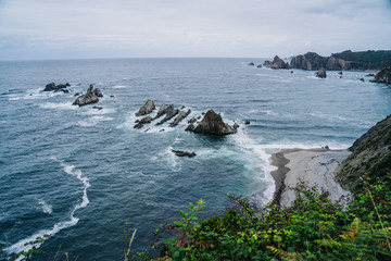 Coastal area with stones and large sharp rocks in the sea