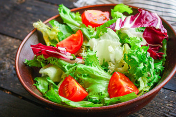 Healthy salad, leaves mix salad (mix micro greens, cucumber, tomato, onion, other ingredients) keto or paleo diet. food background. copy space 
