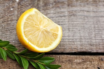 Lemon and grass on a wooden background of planks