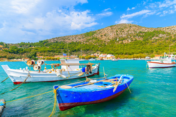 Naklejka na ściany i meble Colourful Greek fishing boats on turquoise sea in Posidonio bay, Samos island, Greece