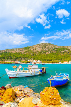 Colourful Greek fishing boats with nets on shore in Posidonio bay, Samos island, Greece