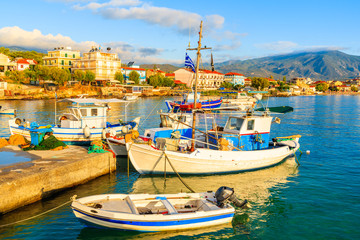 Fototapeta premium Greek fishing boats mooring at sunrise in Ireon port, Samos island, Greece