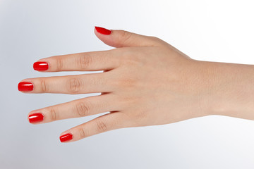 fingernails painted in glossy red.