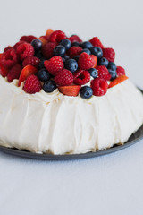 Tasty summer berry baiser pavlova cake with strawberries, raspberries and blueberries