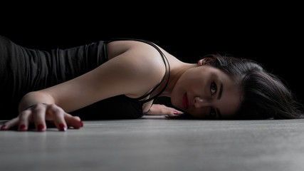 Fototapeta na wymiar Portrait of young woman lying down on a floor
