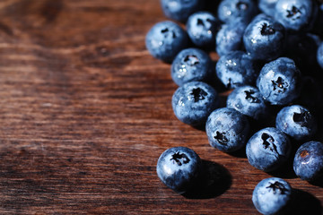 Water drops on ripe sweet blueberry. Fresh blueberries background with copy space for your text. Vegan and vegetarian concept. Macro texture of blueberry berries.