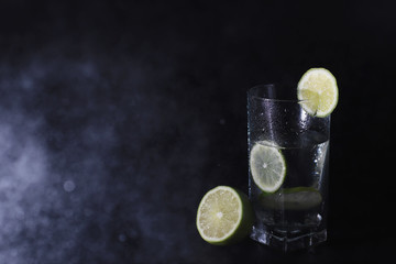 Lime water. Drinking water with fresh lime. Mineral water. Healthy, mineral-rich, refreshing water with lime.